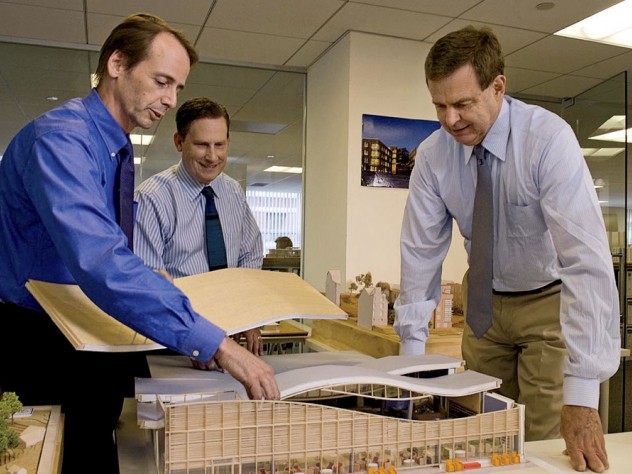 Photograph by Jim Harrison Principals Clifford Gayley, Douglas Johnston, and Rawn discuss a model in their office.