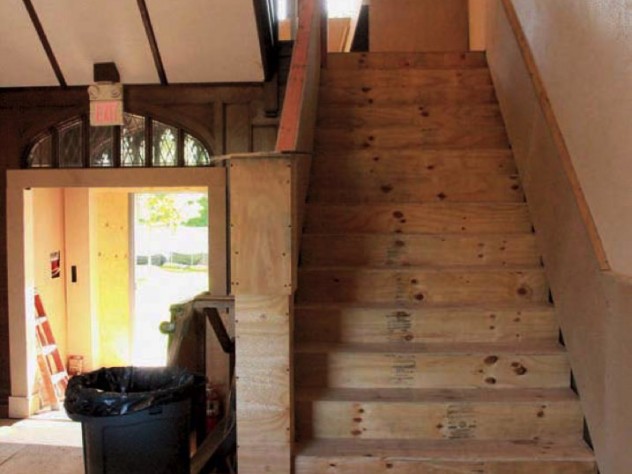 Photograph showing protection of Harvard Divinity School’s Andover Hall interior stairway during pre-construction demolition