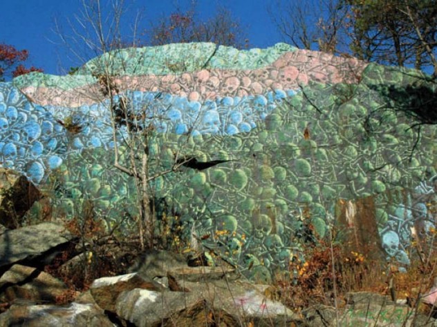 Spray-painted skull mural on climbable rockface near the Lynn Woods Reservation