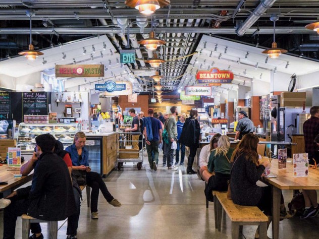 An indoor photo of people eating and shopping at Boston Public Market