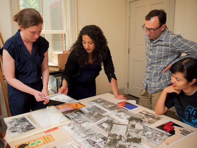 Hinton arranges materials for the Angela Davis exhibit with (from left) Radcliffe arts program manager Meg Rotzel, gallery coordinator Joe Zane, and Pforzheimer fellow Jackie Wang.