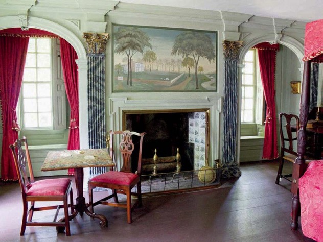 A grand bedroom with four-poster bed and elegant fireplace in the main house.