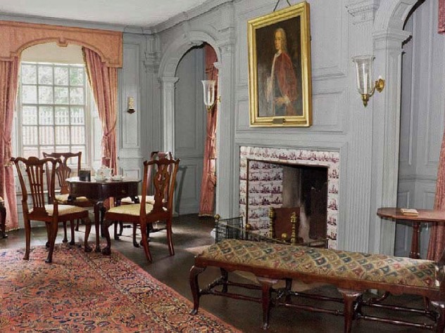 A grand reception room in the main house with an oil portrait hanging above the elegant fireplace.