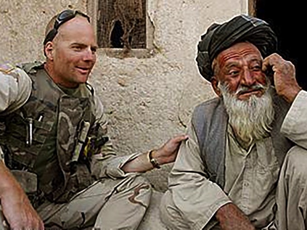 Photograph of Kit Parker on duty in Afghanistan, spring 2003, with a village leader in Kandahar Province