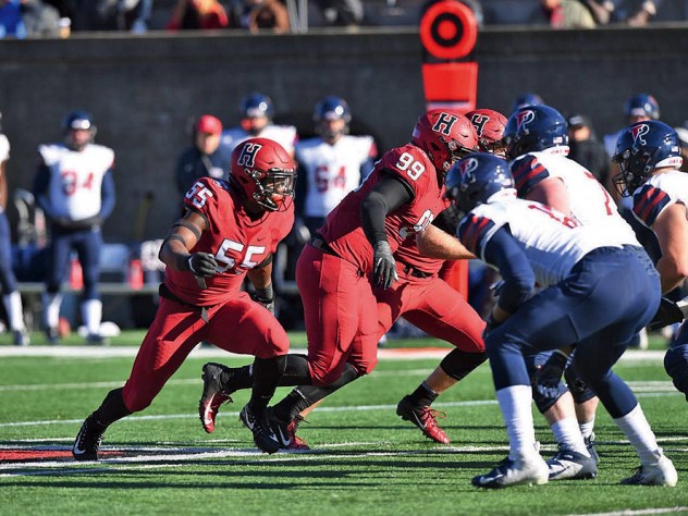 players from two opposing teams line up at line of scrimmage.