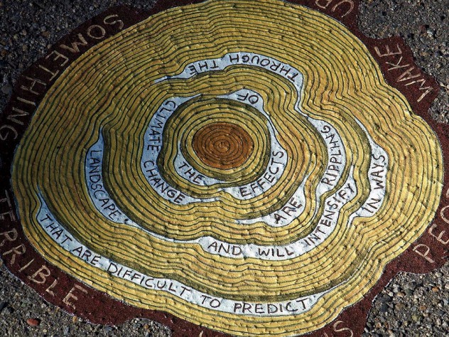 An image from Gilens's "Reading Forest" installation, a sketched cross-section of a tress with words interspersed in the rings. They read: "The effects of climate change are rippling through the landscape and will intensify in ways that are difficult to predict."