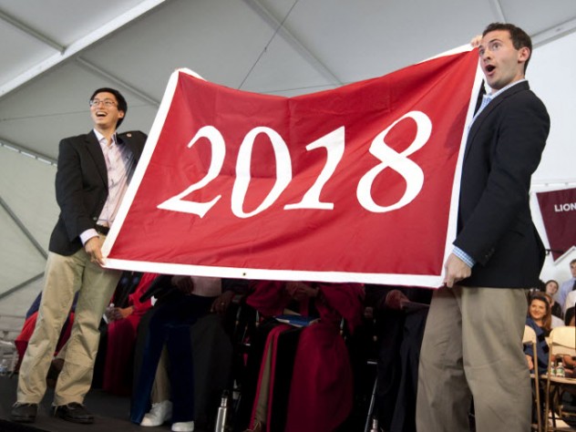 Photograph by Michelle Jay for Harvard University Undergraduate Council vice president Sietse Goffard ’15 (at left) and president Gus Mayopoulos ’15 present the freshmen with their class banner.