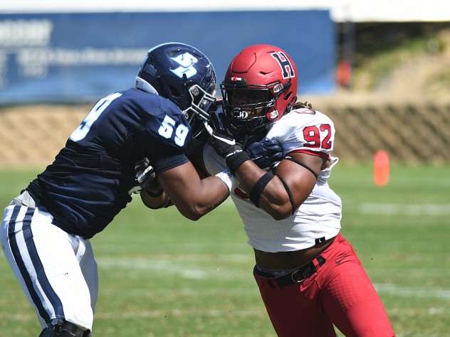 Standoff: Harvard junior defensive lineman Nasir Darnell (92) found his path blocked by San Diego's DJ Wright.