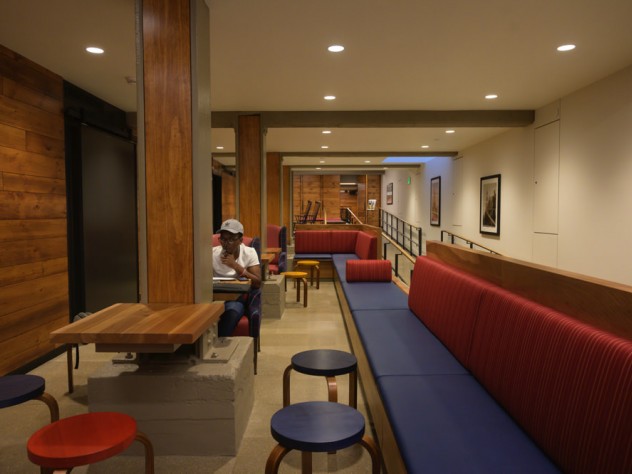 A student sitting in a basement common space.