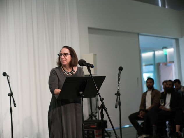 Associate provost for arts and culture Lori Gross at the microphone