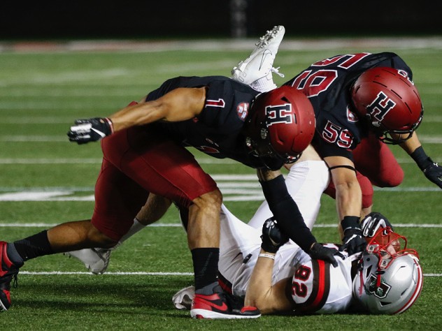 Tag team: Harvard senior captain and defensive back Wes Ogsbury Jr. (1) and senior linebacker Joey Goodman (59) doubled up on Brown end Dan Gemmell.