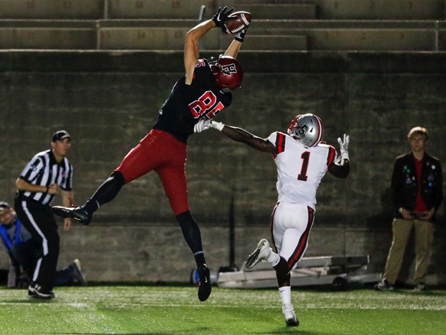 Get on up: On this scoring toss, Harvard's junior tight end Adam West was too high for Brown's BJ Ubani to handle.