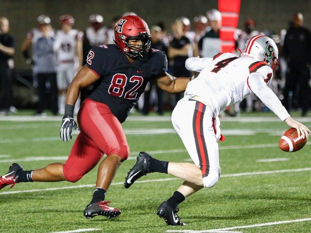 Hot pursuit: Harvard's Anthony Nelson (82) was one of a corps of sophomore defensive linemen to pressure Brown quarterback EJ Perry.