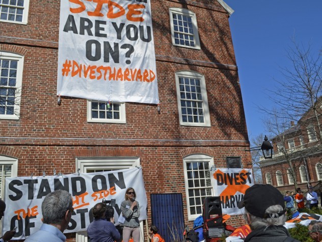 Divest Harvard signs hangs from Mass. Hall.