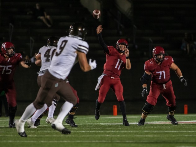 Charlie Dean throws a football across field.