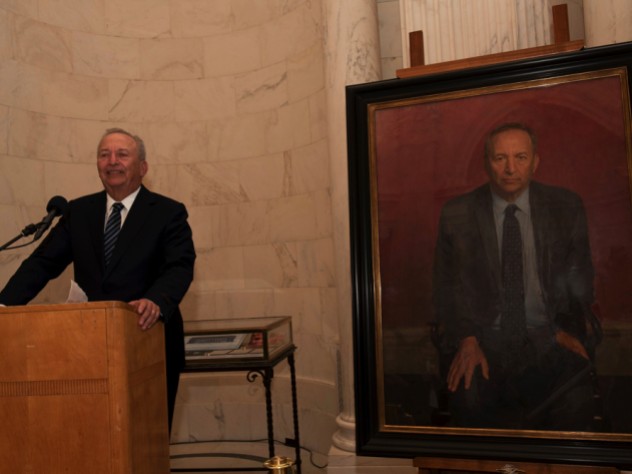 Lawrence H. Summers at the lectern next to his official portrait