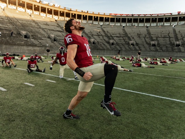 Harvard football players limbering up for season-opening game