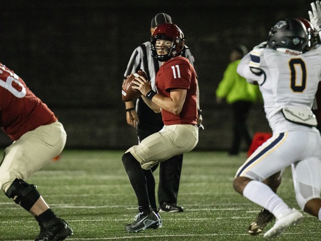 Photograph of quarterback Charlie Dean under pressure before finding his rhythm