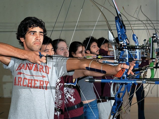 Samuel Saidel-Goley (foreground) and Archery Club colleagues draw their bows.