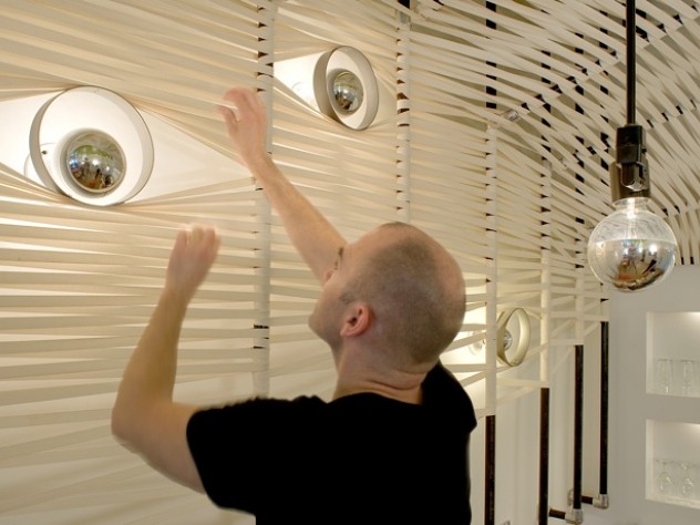 Photograph courtesy of MERGE architects Custom light fixtures at Yak & Yeti symbolize the "nine eyes of the Buddha."