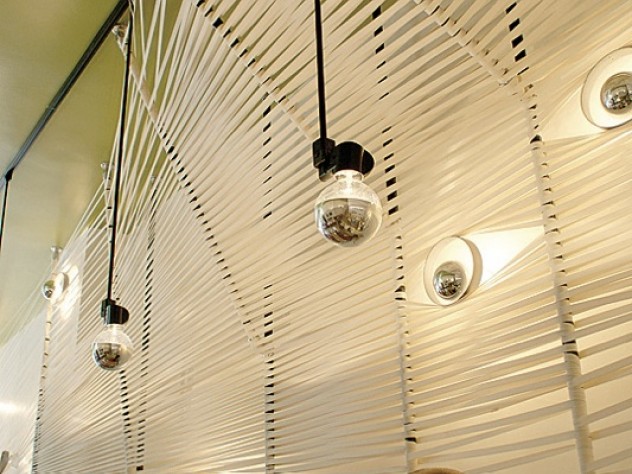 Photograph courtesy of MERGE architects Cotton straps at Yak & Yeti create a unique wall and ceiling.