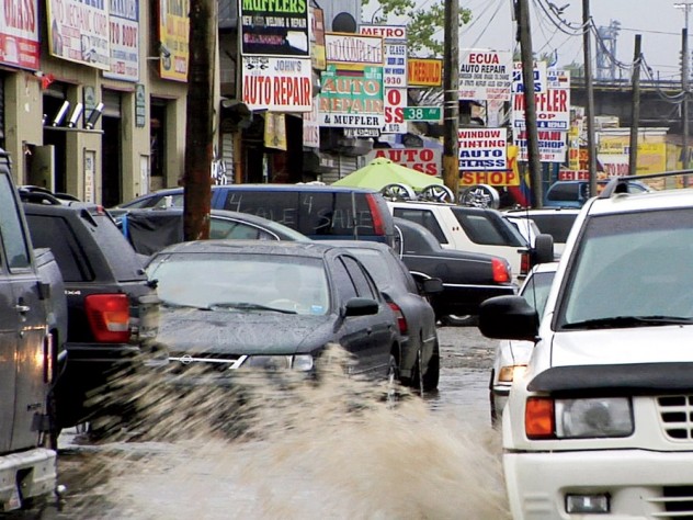 Puddles of water, a leitmotif in <i>Foreign Parts,</i> fill the rutted streets of Willets Point in Queens, a mecca for auto repair and parts.