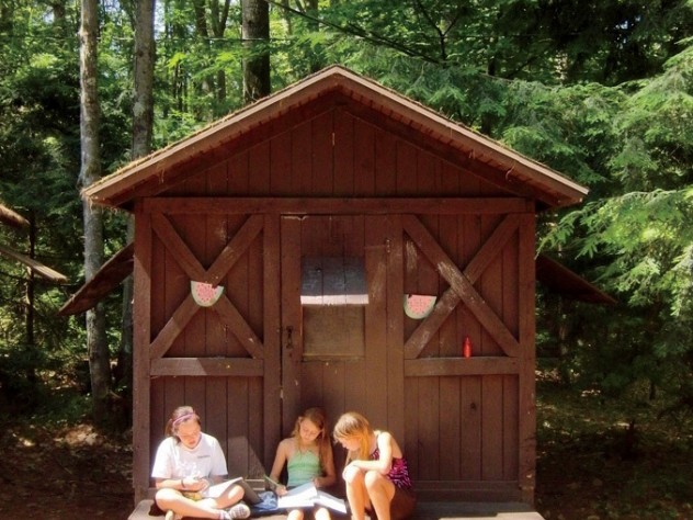 Campers outside one of the two-person cabins they call home