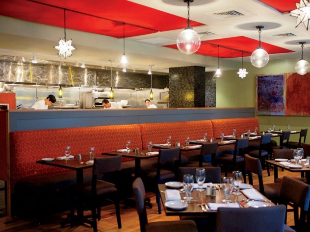 Evoo’s earthy food is served in a modern, open interior with a view of the kitchen.