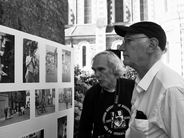Peter Winship (left) and Bill Christian examine photographs recalling their days as student researchers in the village of Chanzeaux, under the tutelage of the late Laurence Wylie.
