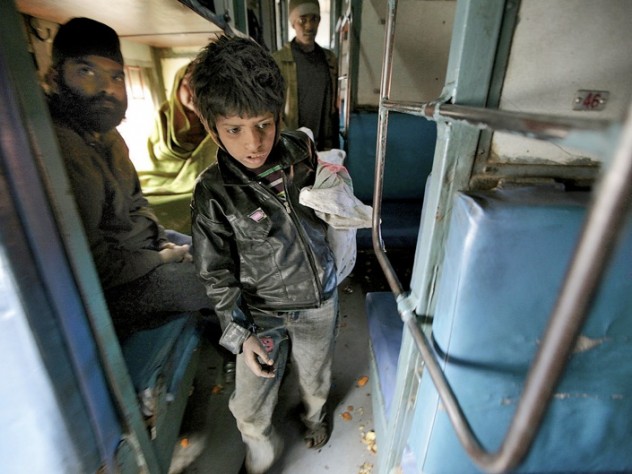 Photograph by Peter Pereira At the train station in Jaipur, India, collecting empty water bottles fetches about 100 rupees ($2) a day. Here, eight-year-old Badal searches inside a train car.