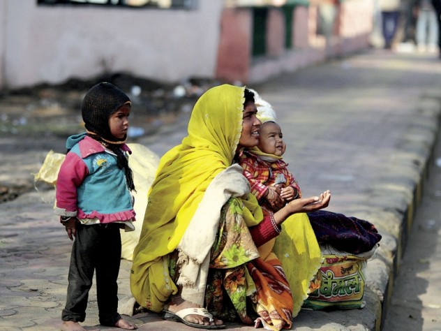 Photograph by Peter Pereira Families make their homes on a sidewalk adjacent to the train station, and survive by begging.