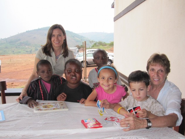 Photograph courtesy of Theresa Betancourt Betancourt with her children, Anna and Joey; her mother, Norma; and their friends Didier, Yvonne, and Pabelo at the Inshuti Mu Buzima/Partners In Health District Hospital in Rwanda