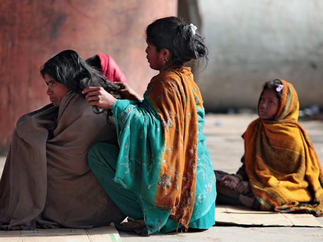 Photograph by Peter Pereira Many families make their homes on sidewalks near the train station in Jaipur, India.