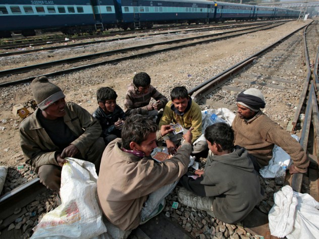 Photograph by Peter Pereira It's a hard life for boys who fall into this livelihood. They socialize with older men, gambling to pass the time between trains and using drugs to ease the shame of poverty and the pain of hunger and cold.