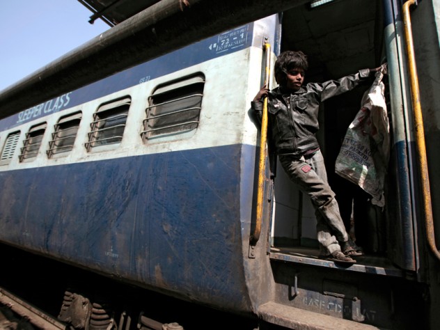 Photograph by Peter Pereira One of the bottle collectors strikes a pose. Badal, age 8, has grown up fast. He lives with his mother and siblings in the train station, but instead of sending him to school, his mother relies on him to help bring in money for the family.