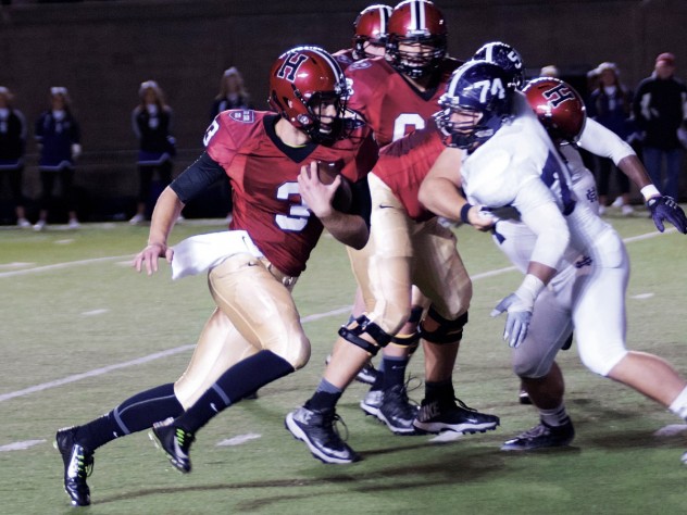Photograph by Robert Worley Thrust into action by an injury to starting QB Connor Hempel, untried Scott Hosch filled in admirably against Holy Cross, directing the Crimson to its second touchdown, which he scored on a seven-yard run.