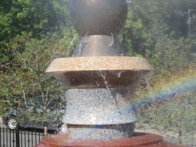 Photograph courtesy of Ross Miller Mist and jets of water spray from the top of the fountain at a Roxbury Park.