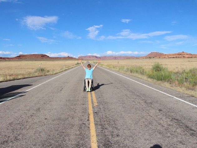 Kunho Kim celebrating on a deserted road in Canyonlands National Park, Utah