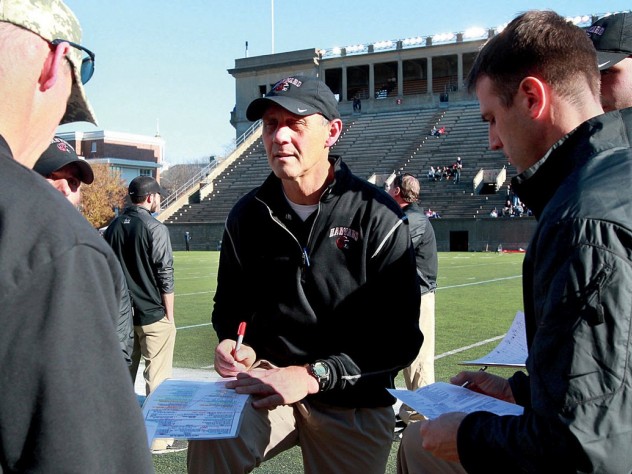The year before, at the Stadium, Murphy consulted with his assistants before a 38-30 victory over Bagnoli and his Quakers.