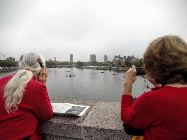 Julie Tonks, camera at the ready, and Abbie Bingham Endicott scan the river for their husbands' boat.