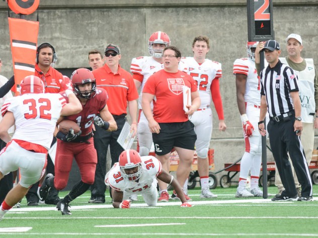 On one of his four receptions, Harvard's Joe Foster proved elusive for Big Red defenders DJ Woullard (31) and Daniel Crocher.