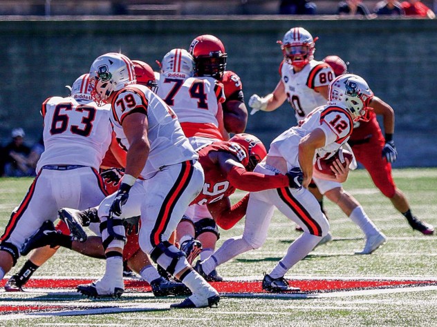 Junior defensive end DJ Bailey (99) registered one of five Harvard sacks against Brown quarterback Nick Duncan.
