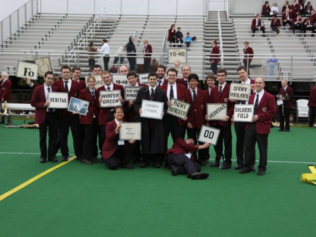 Band members display the signal cards for Harvard fight songs.