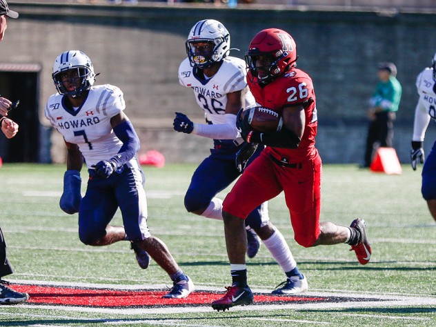 Harvard's DeMarkes Stradford zooms past Howard’s Ray Williams (7) and Deionte Davis (36).