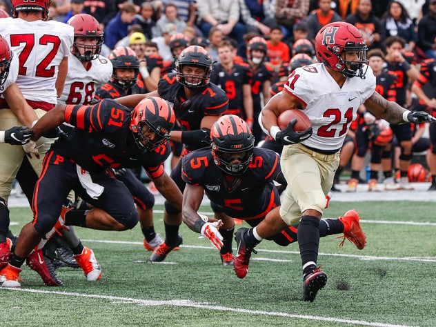 Aidan Borguet of Harvard runs by Princeton's Samuel Wright and Jeremiah Tyler.