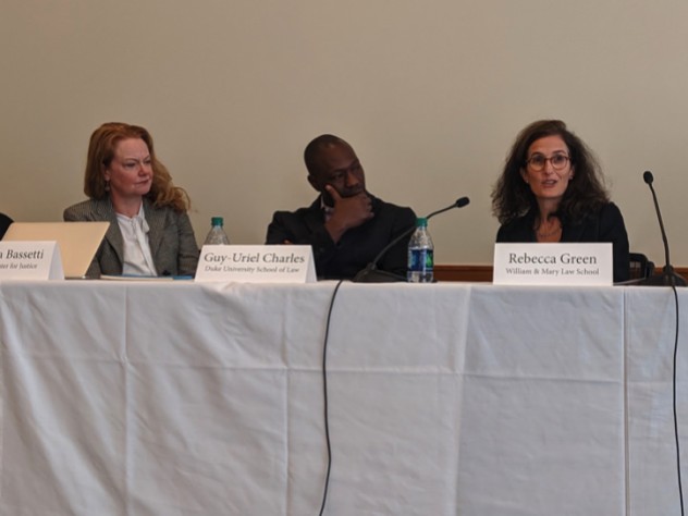 Photo of three speakers seated at a table