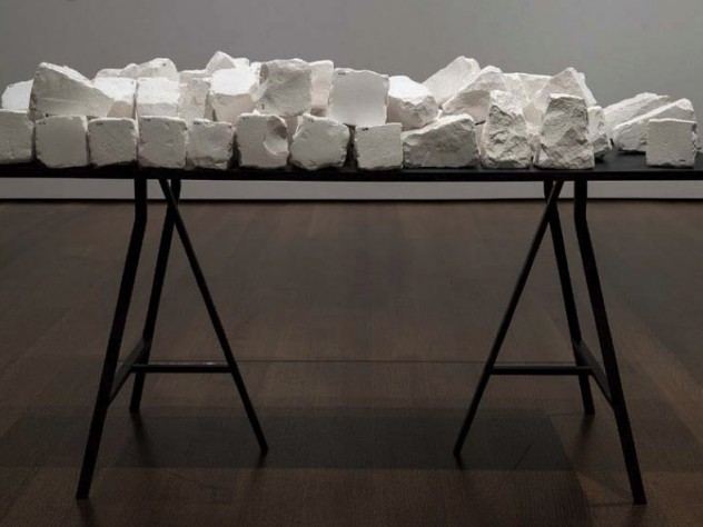A plain black table covered with white cobblestones