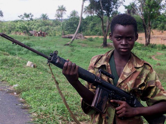 Photograph of a child soldier from Sierra Leone holding a self-loading rifle