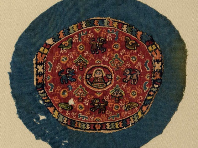 An intricate woven medallion fragment surrounds a human bust with geometrical shapes, vegetal motifs, and strange quadrupeds.