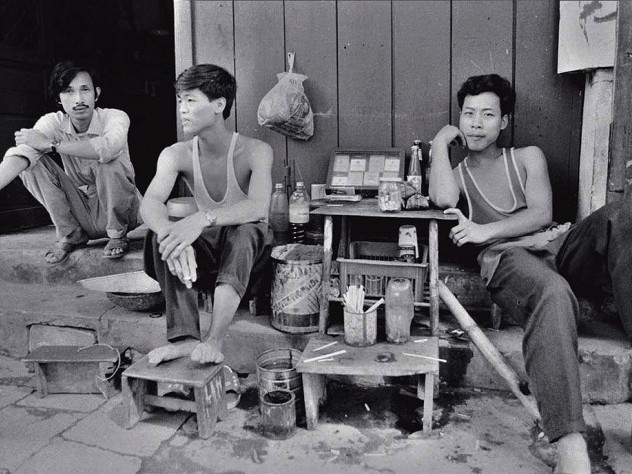 Black and white photo, titled “Three Tobacconists”
